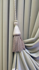 brown and white broom on white textile