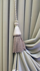 brown and white broom on white textile