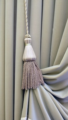 brown and white broom on white textile