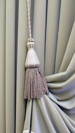 brown and white broom on white textile