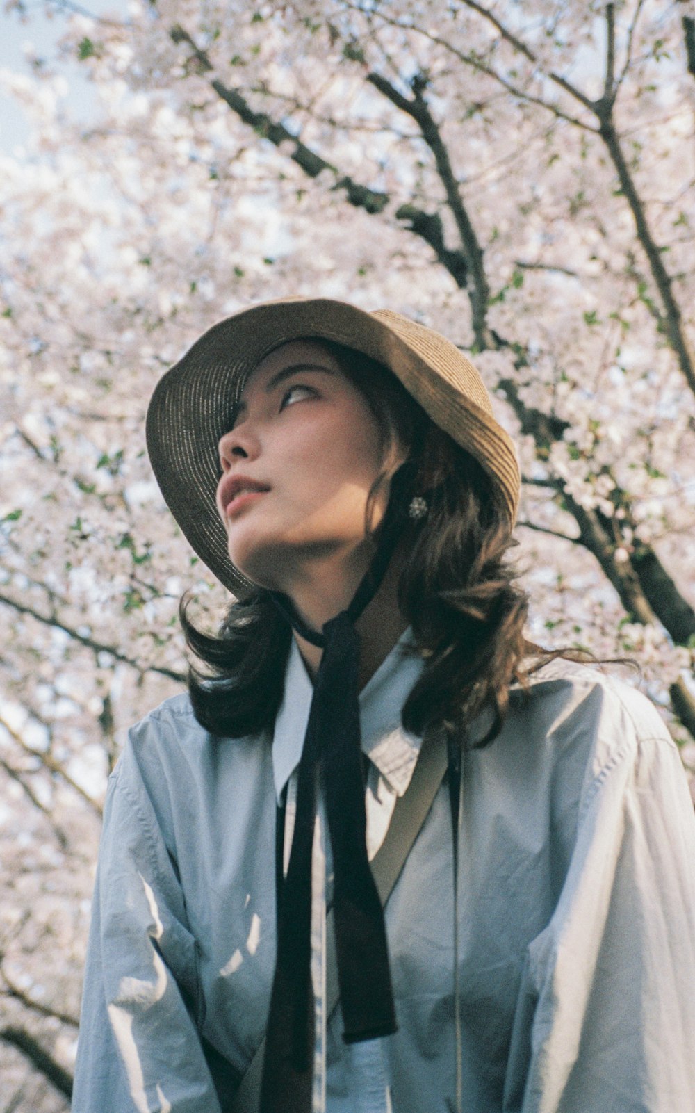 woman in gray jacket wearing brown hat