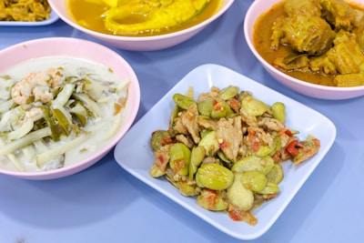 A vibrant selection of vegetarian dishes displayed on a wooden table.