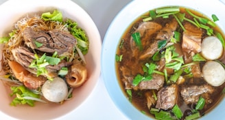 A bowl filled with steaming hot bakso meatballs in rich broth.