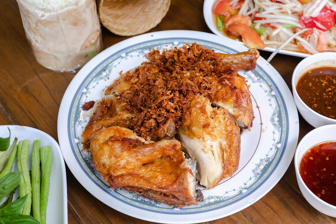 fried chicken on white ceramic plate, Crisopy fried whole chicken at Polo Fried Chicken in Bangkok.