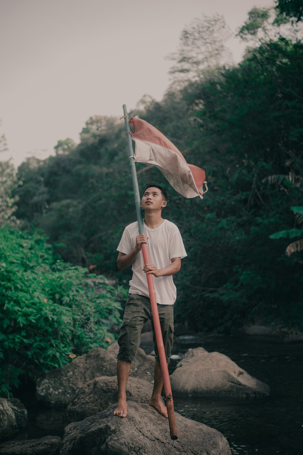 man in brown and white hat holding white umbrella