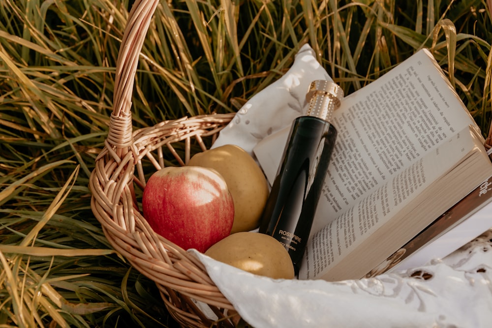 red apple fruit on brown woven basket