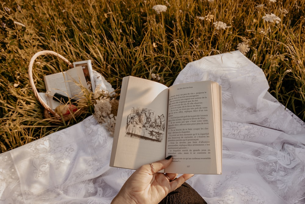 person holding white book page