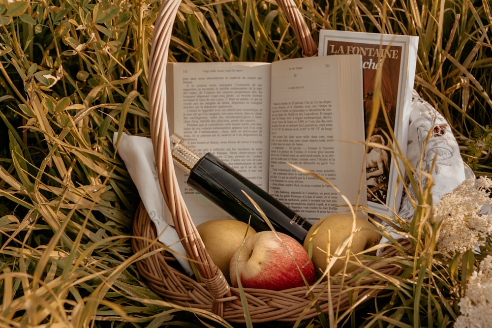 red apple fruit beside yellow round fruit on brown woven basket