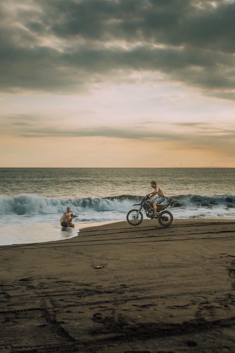 people riding bicycles on beach during daytime