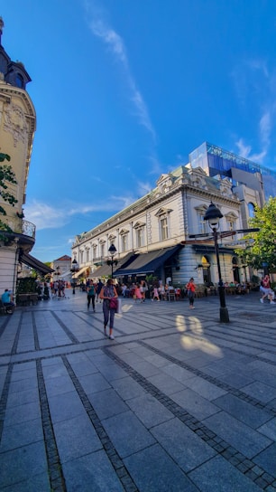 A lively street scene in Reus with people enjoying local cafes and shops on a sunny day.