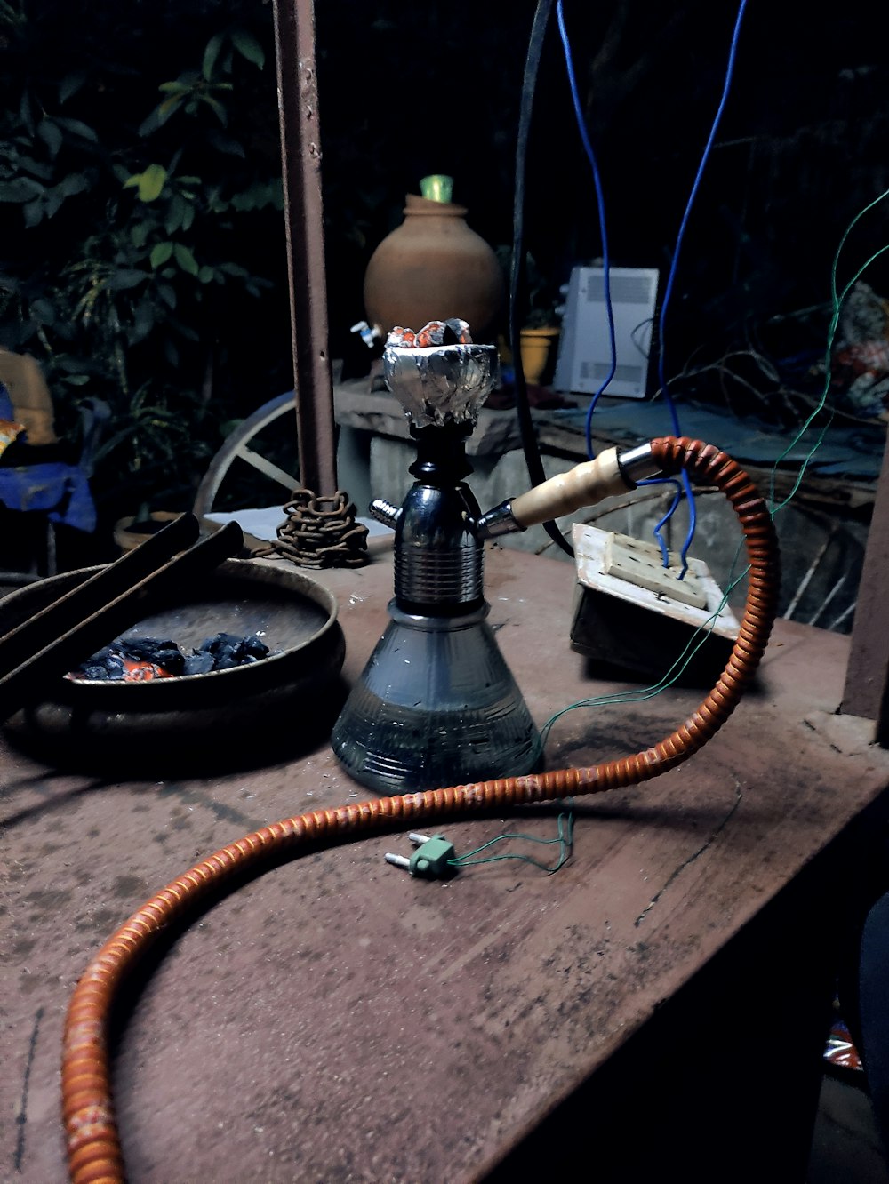 silver and black hookah on brown wooden table