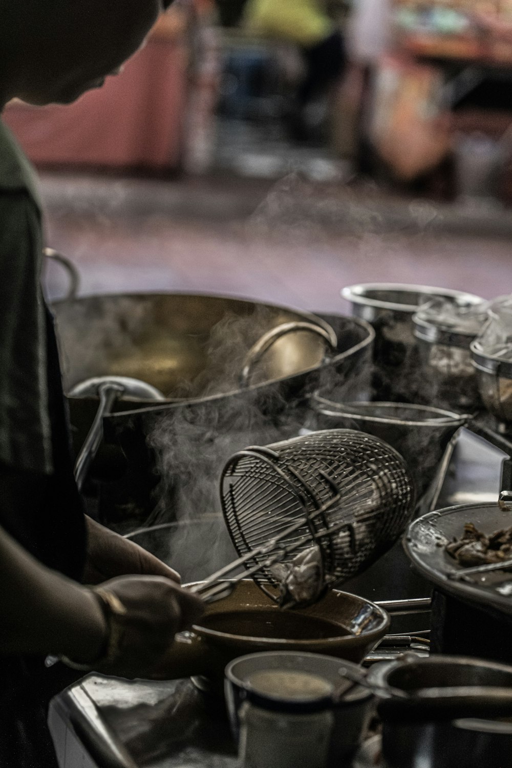 person holding stainless steel cooking pot