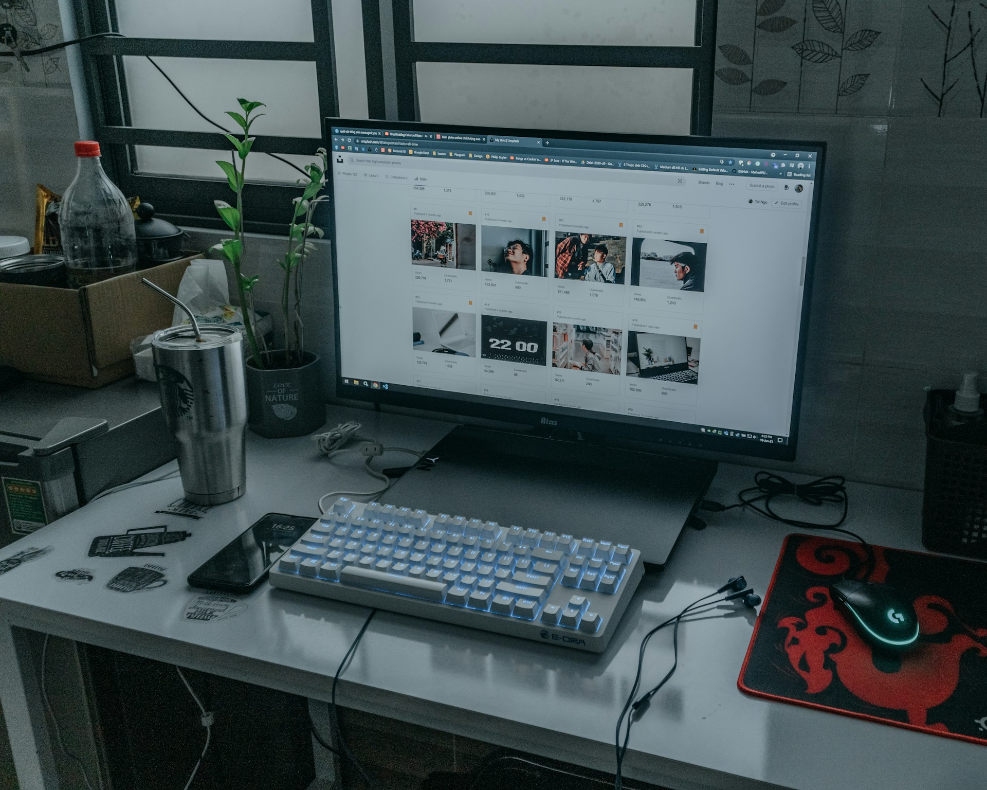 silver imac with white keyboard and silver tumbler
