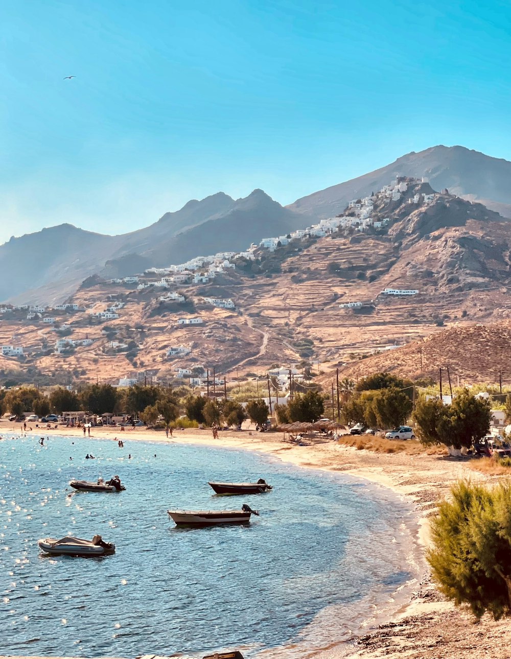 boats on sea near mountain during daytime