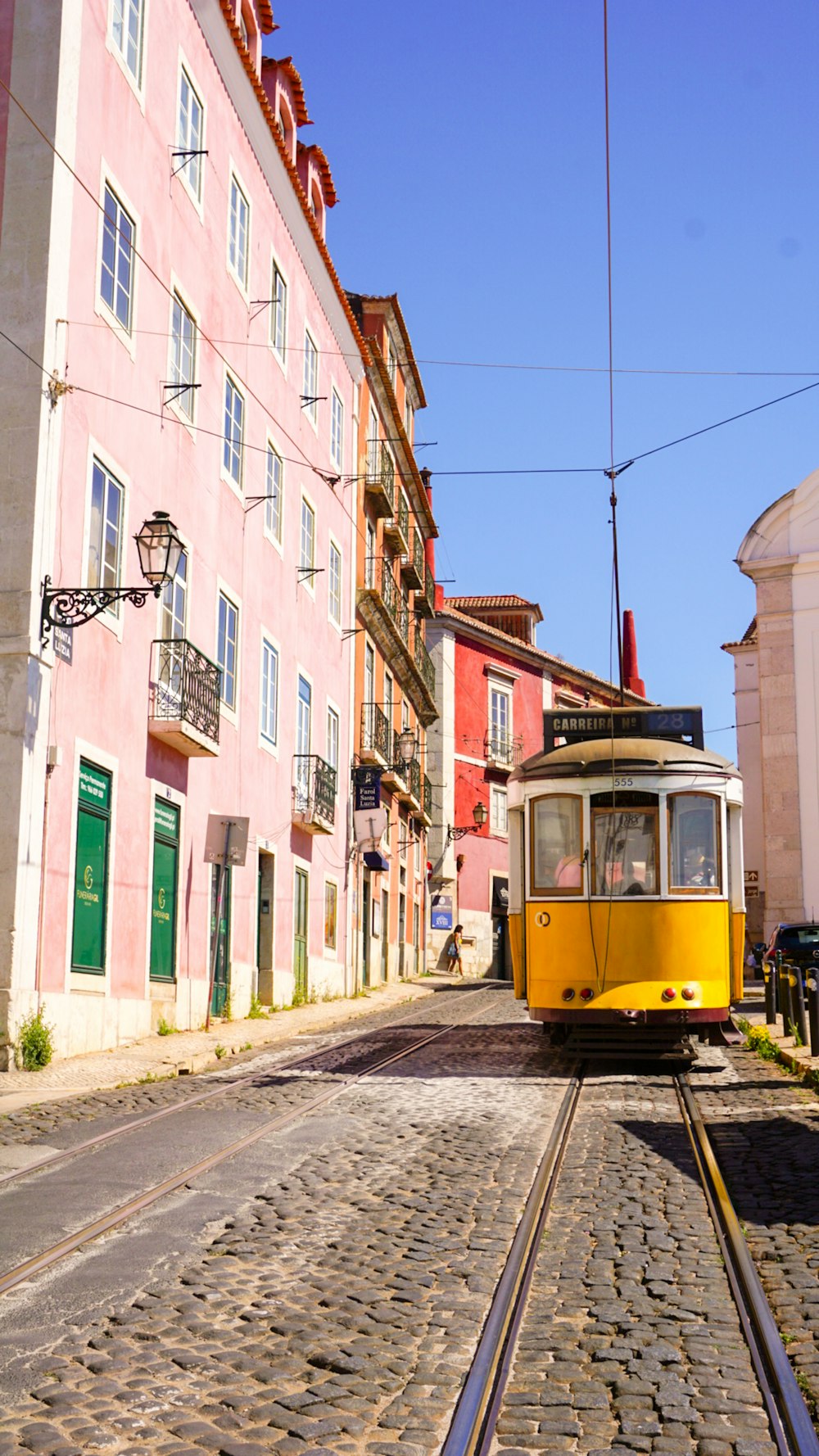 yellow and white tram on street during daytime