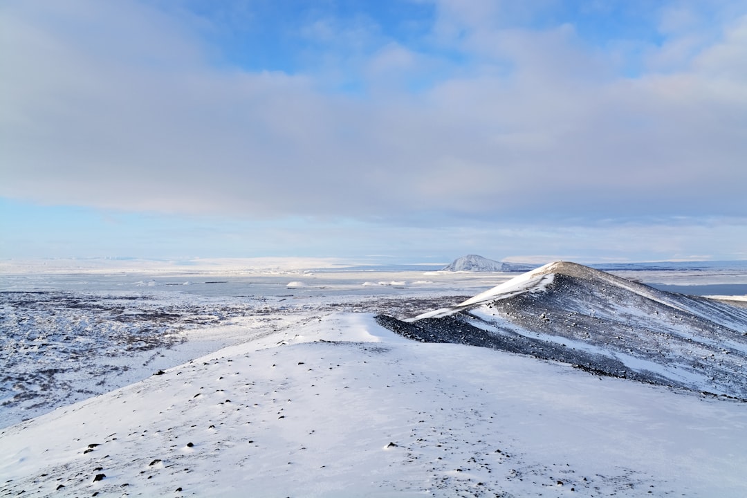 snow covered field under blue sky during daytime