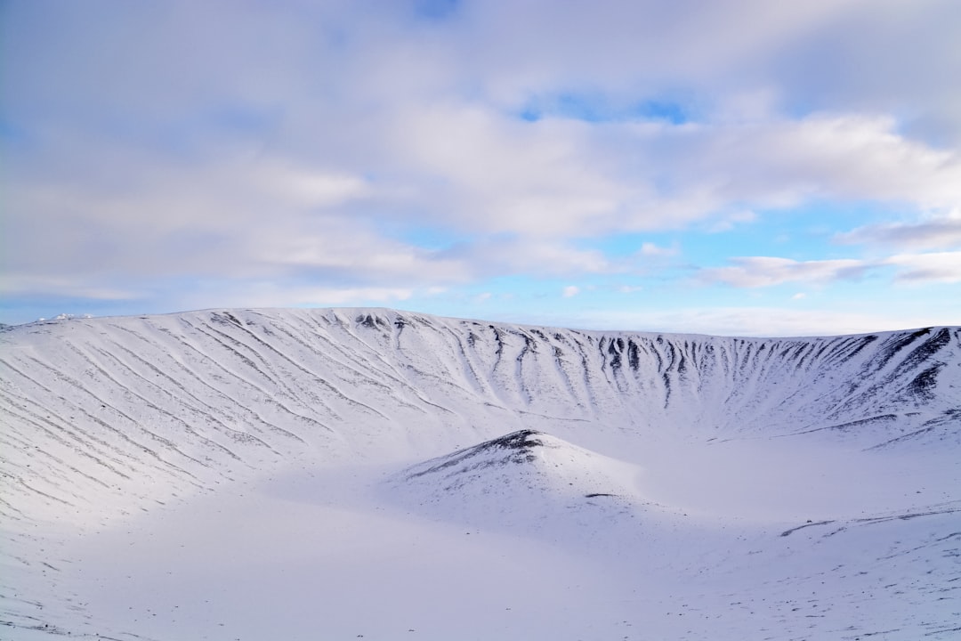 snow covered mountain under cloudy sky during daytime