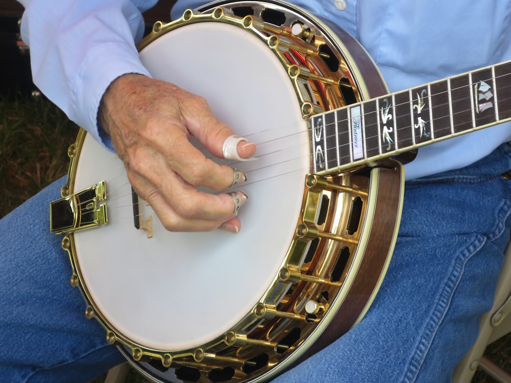 person holding white and brown round drum