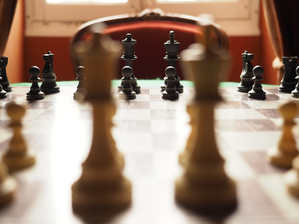 a chess board with a large set of chess pieces