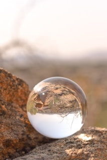 A close-up of a crystal ball resting on a velvet cloth.