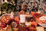 clear glass bottle surrounded by fruits