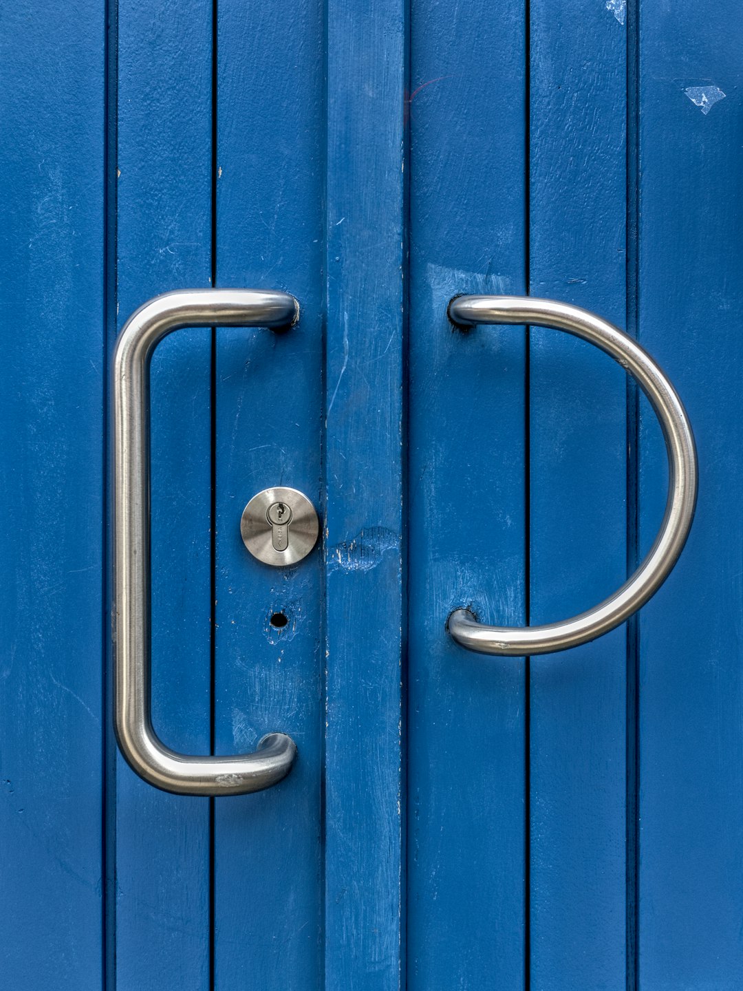 blue wooden door with silver handle