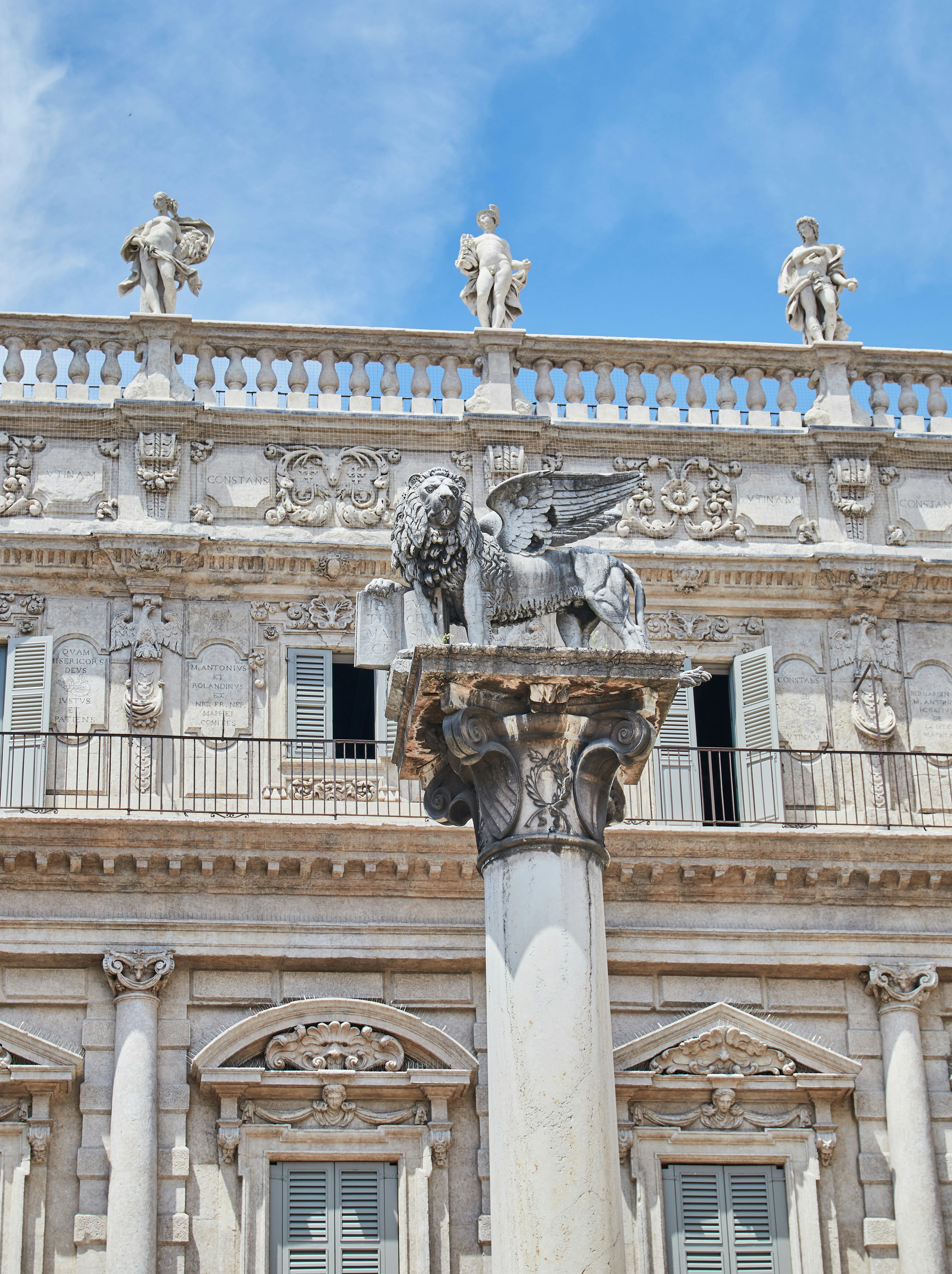 white concrete building with statue of man riding horse