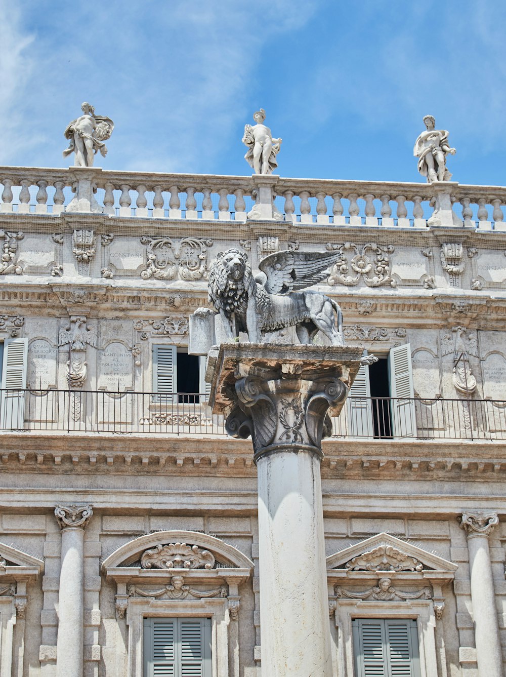 white concrete building with statue of man riding horse