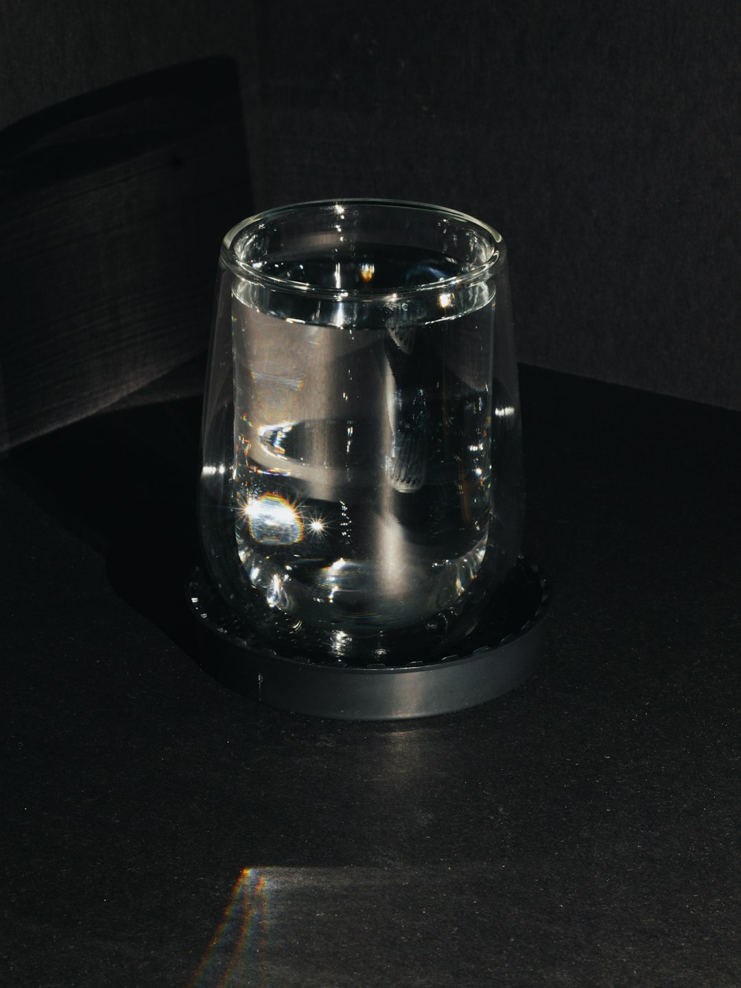 clear glass container on black table