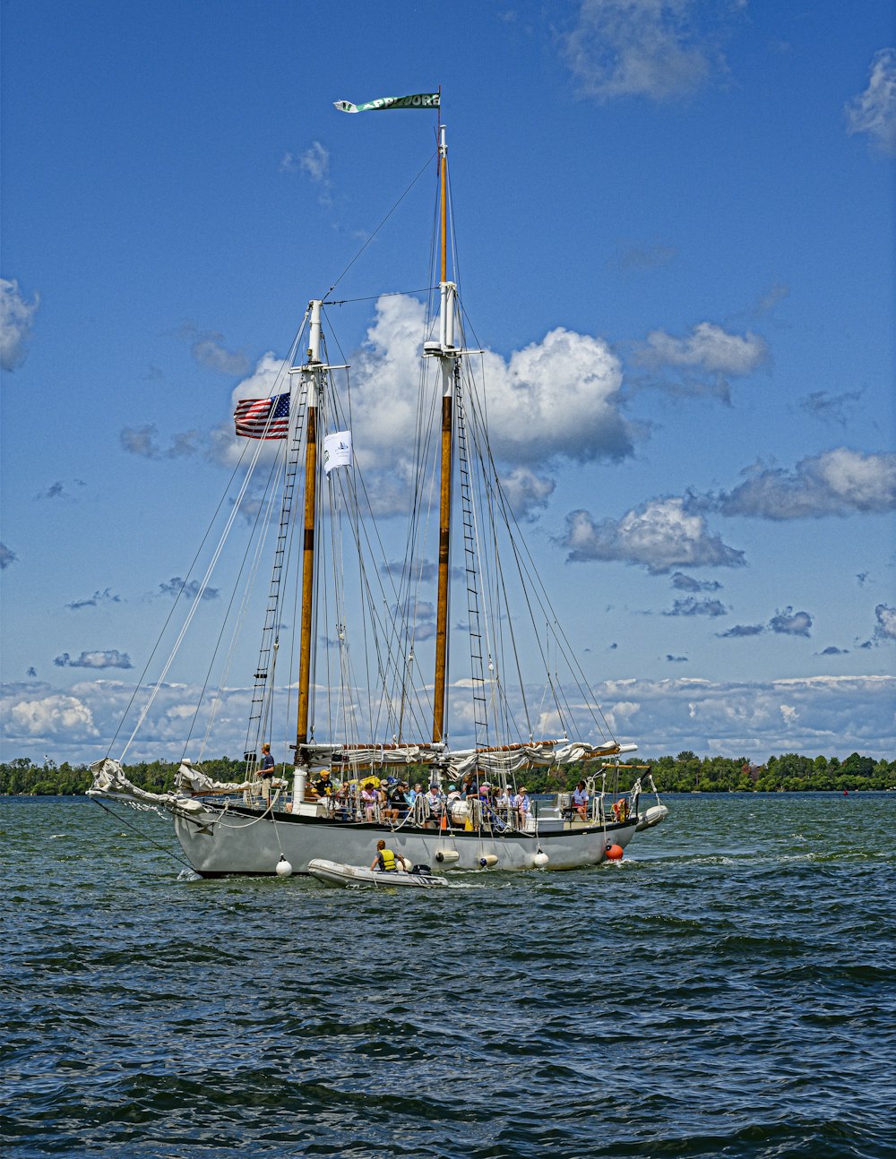 white sail boat on sea under blue sky during daytime