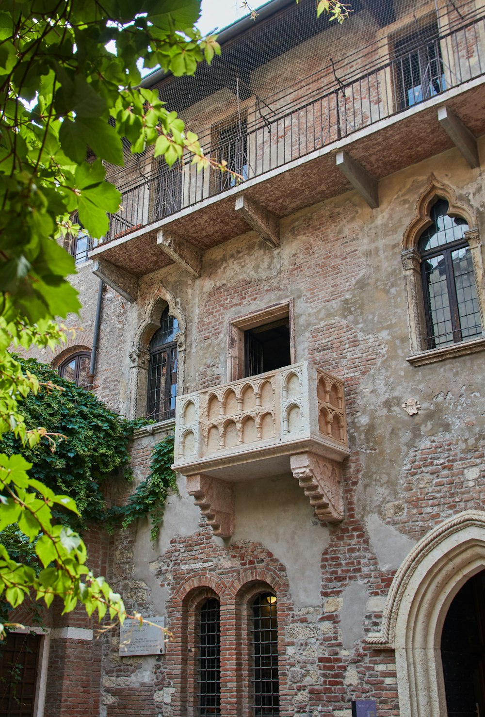 brown brick building with green plants