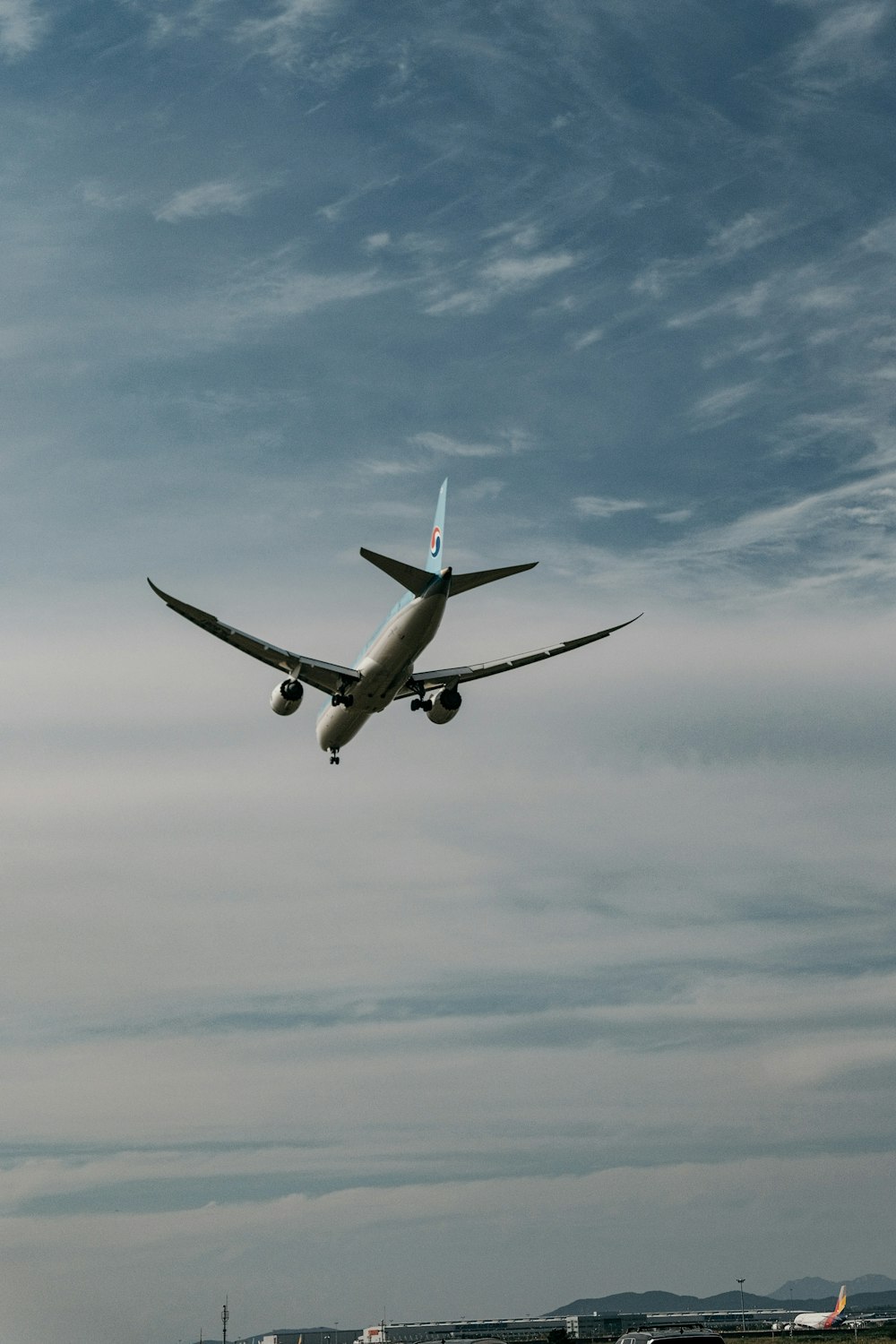 avion blanc volant sous le ciel bleu pendant la journée