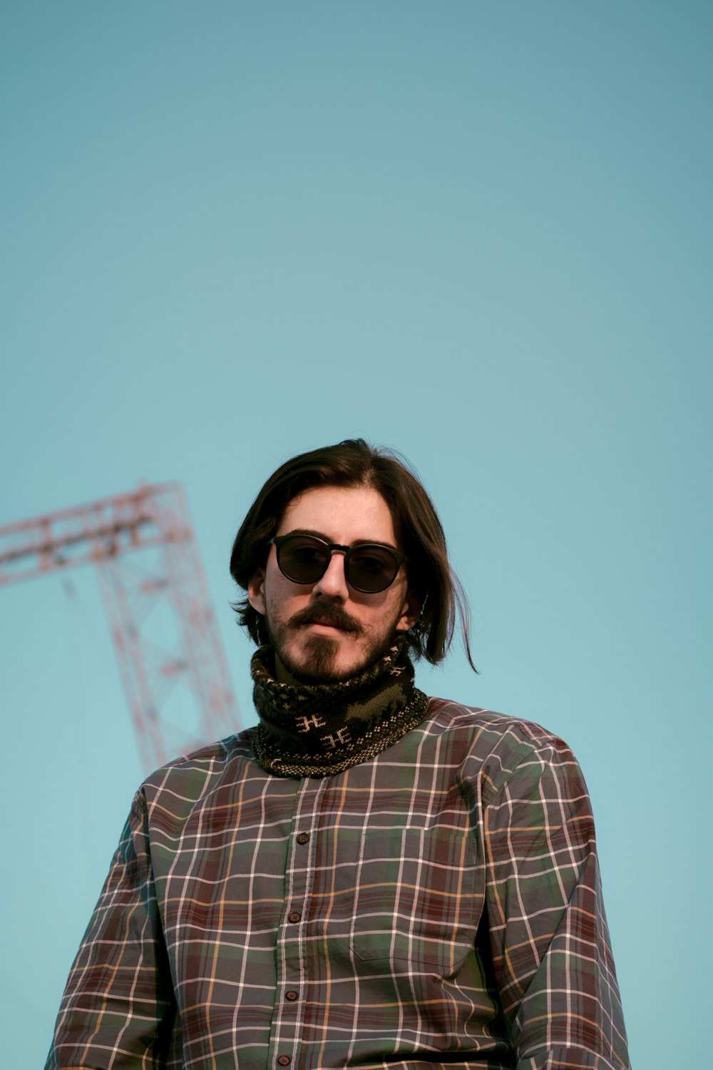 woman in white and black plaid shirt wearing black sunglasses