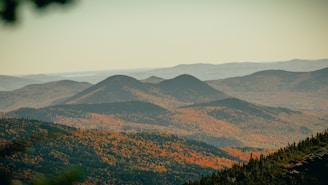 A scenic shot of the Blue Ridge Mountains with rolling hills and colorful foliage.