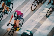 person in green and black shorts riding on black and red bicycle