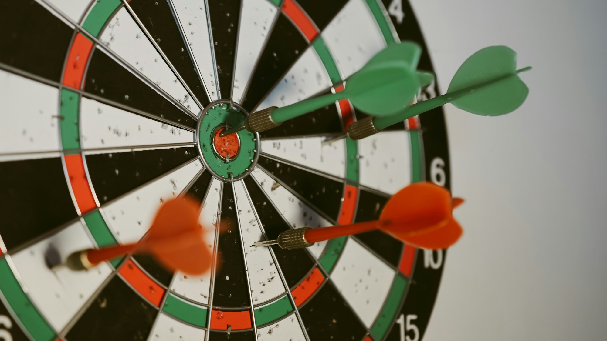Success hitting target aim goal achievement concept background - three darts in bull's eye close up. red three darts arrows in the target center business goal concept