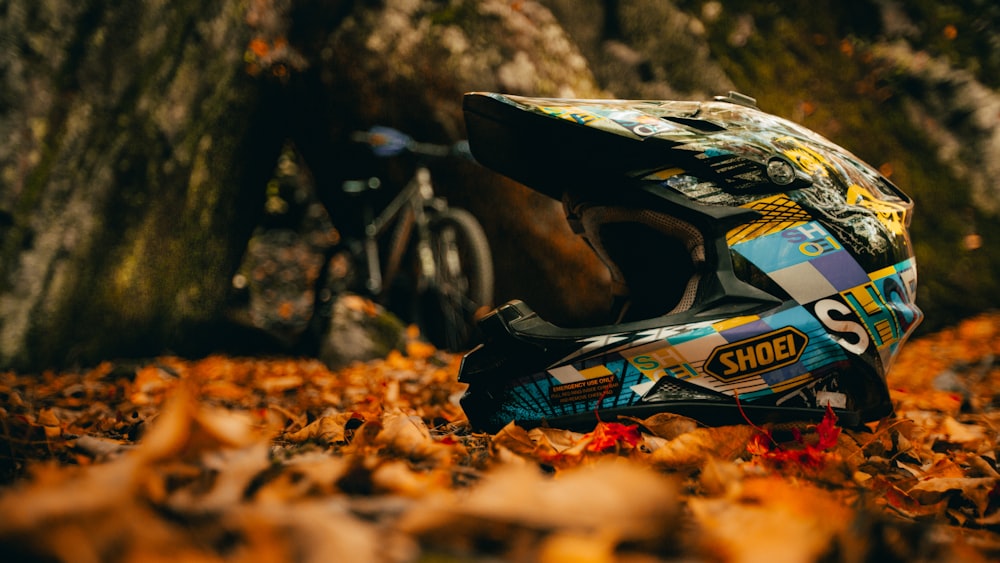 blue and black motorcycle on brown dried leaves