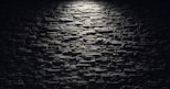 a black and white photo of a brick wall