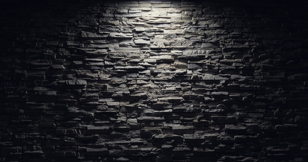 a black and white photo of a brick wall