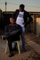 A CVST mental health support worker chatting supportively with a teenager outside the studio during the evening hours.