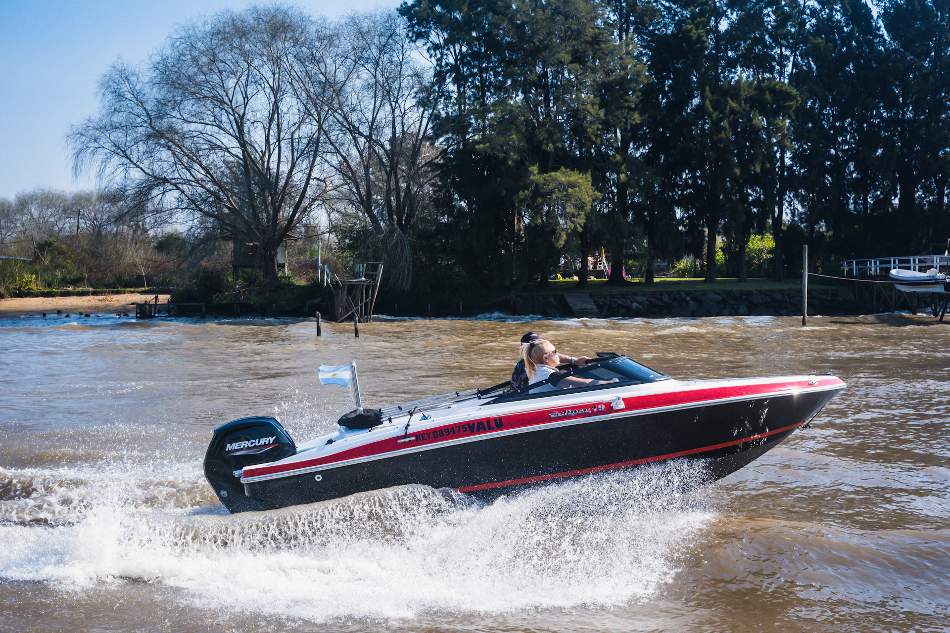 man riding red and white boat on water during daytime
