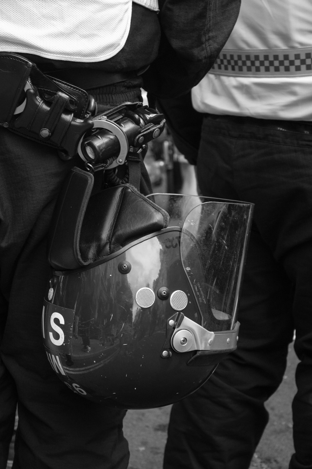 grayscale photo of person holding dslr camera