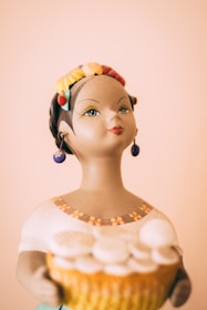 Portrait of a smiling African woman proudly displaying her handcrafted pottery.