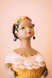 Portrait of a smiling African woman proudly displaying her handcrafted pottery.