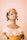 A joyful woman holding a beautifully detailed resin figure with a warm smile