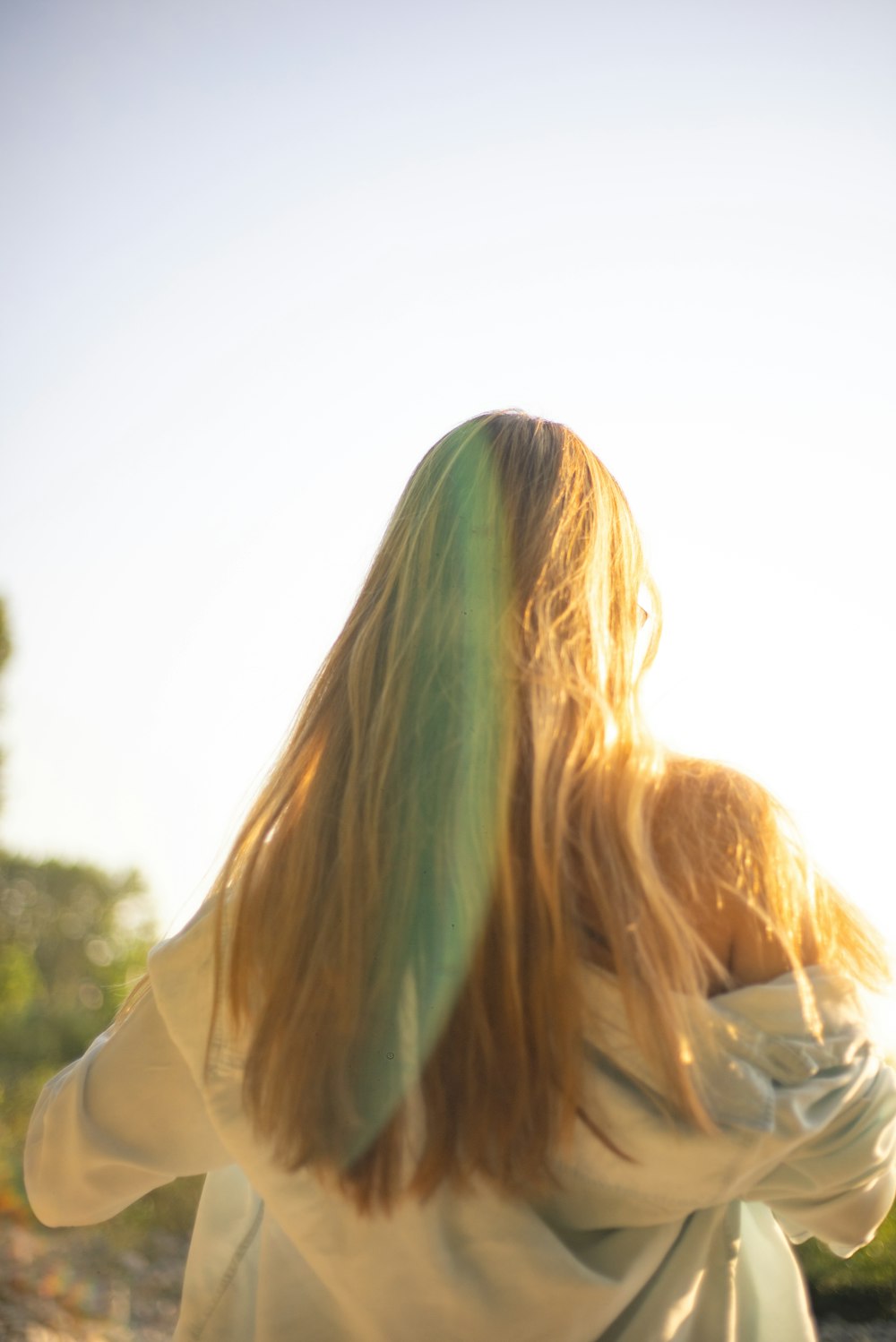 woman in white shirt looking at the sky during daytime