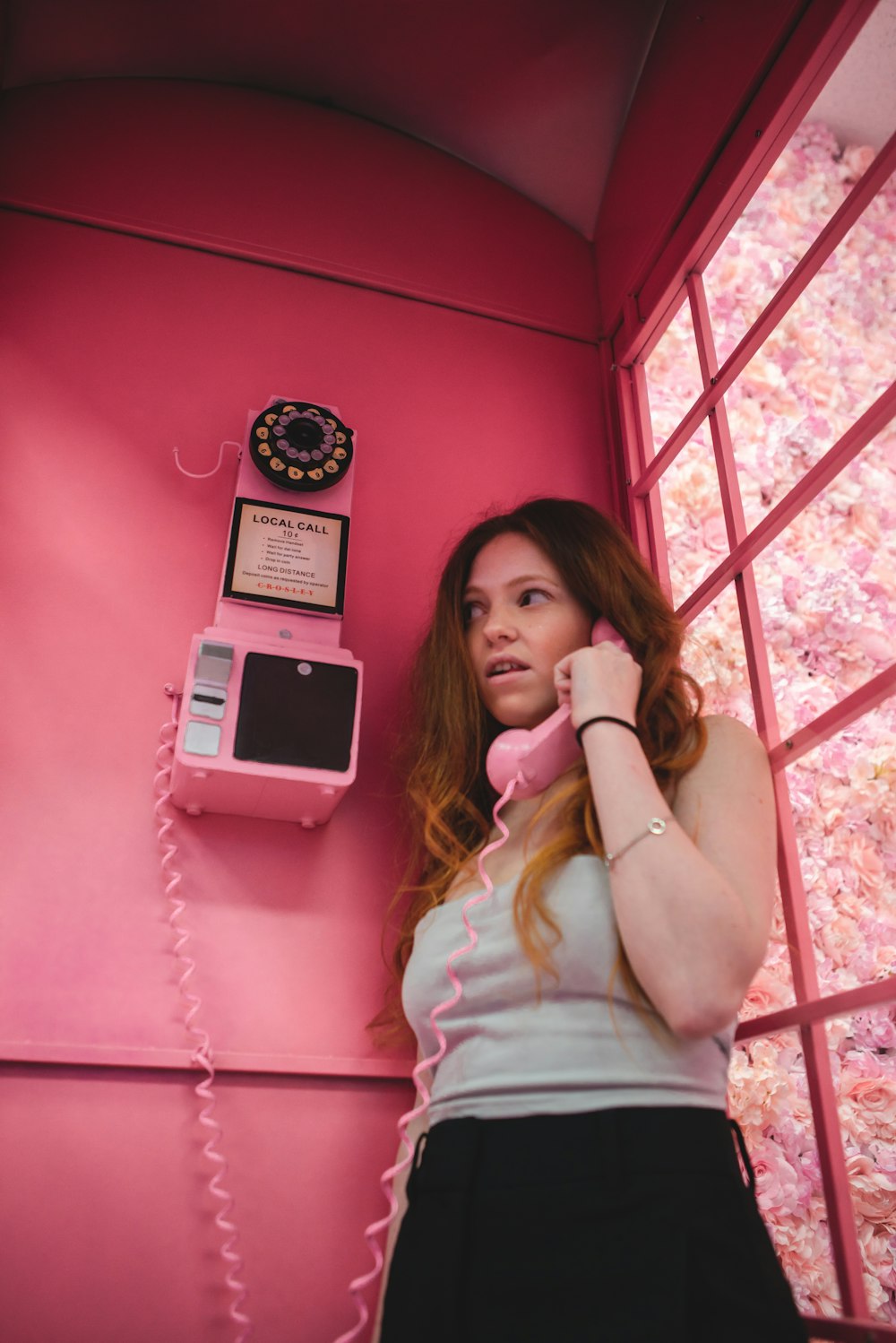 woman in white shirt holding white smartphone