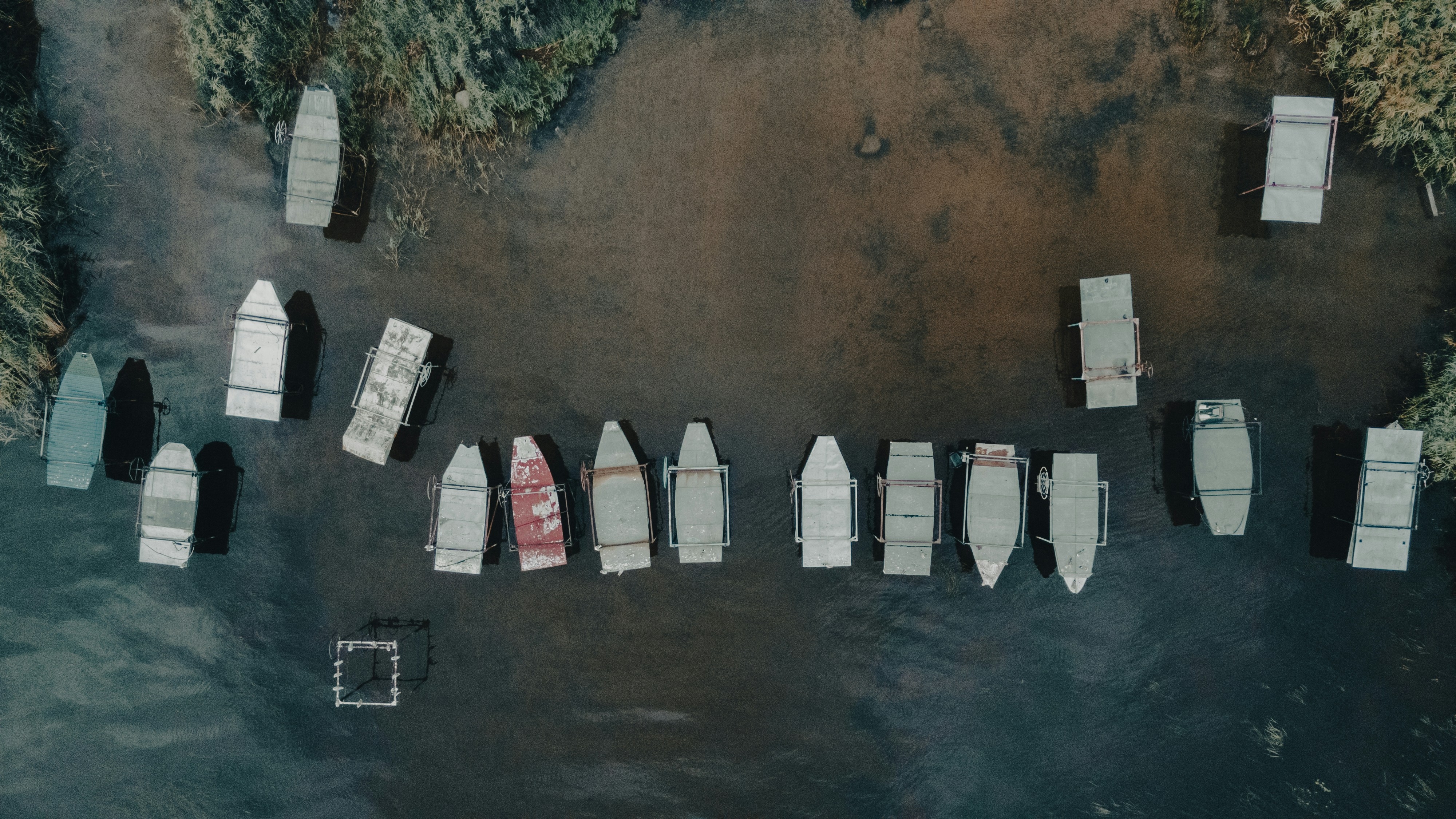 white and red houses on brown sand, Boat stands on the shore of Lake Ladoga