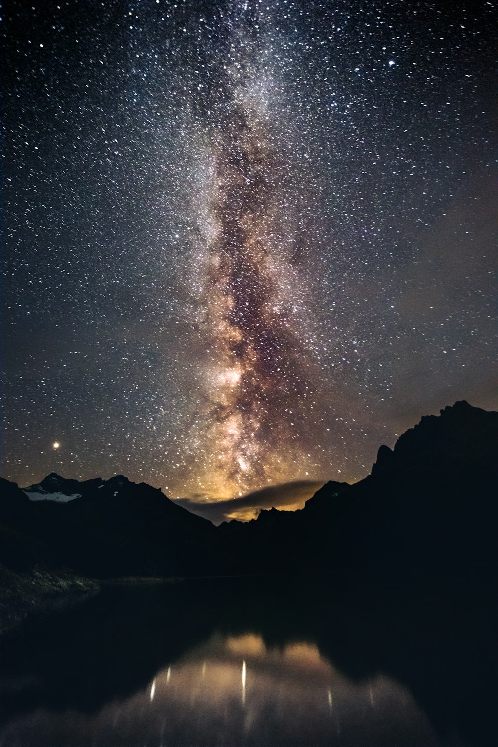 silhouette of mountain under starry night