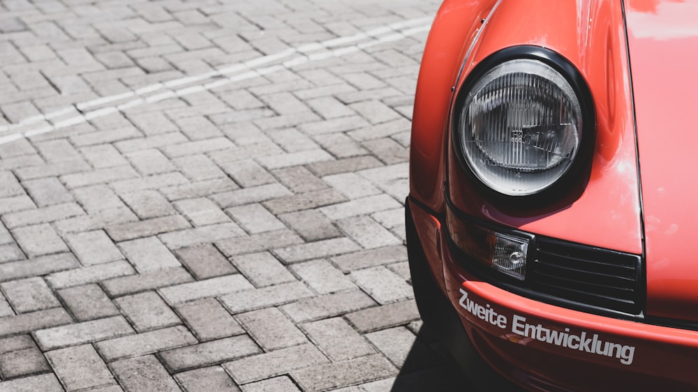 red car on gray brick floor